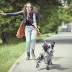 Woman being pulled by a dog on leash