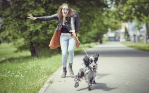Woman being pulled by a dog on leash